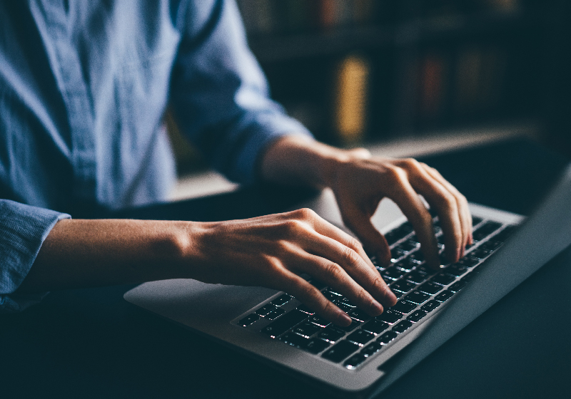 Man sitting and typing on laptop