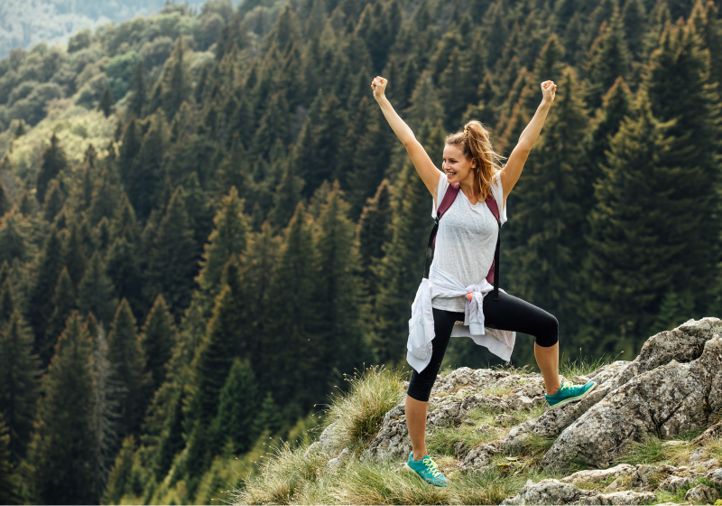 Woman confidently standing on mountain