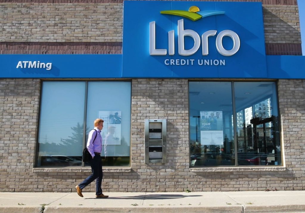 A Libro employee walks into a local branch
