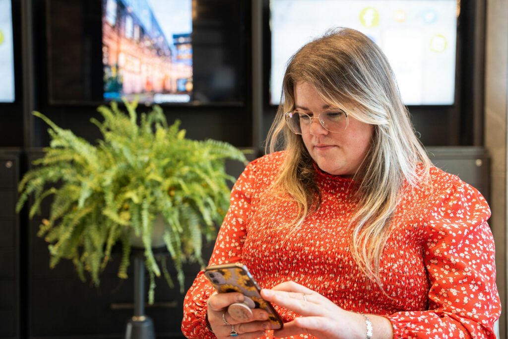 Libro Member on her phone in a Libro branch