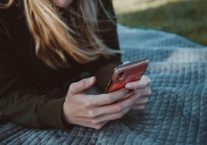 Libro owner sending an e-transfer from a mobile phone while outdoors at a park