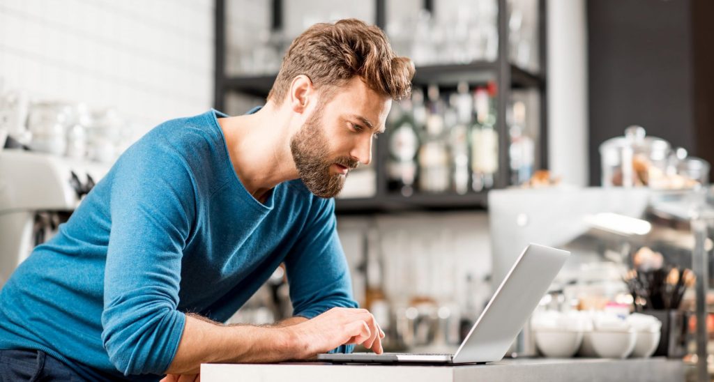 Man working with laptop at the cafe