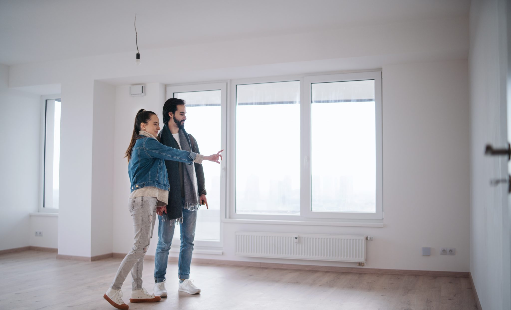 Young couple moving in new flat, new home and relocation concept.