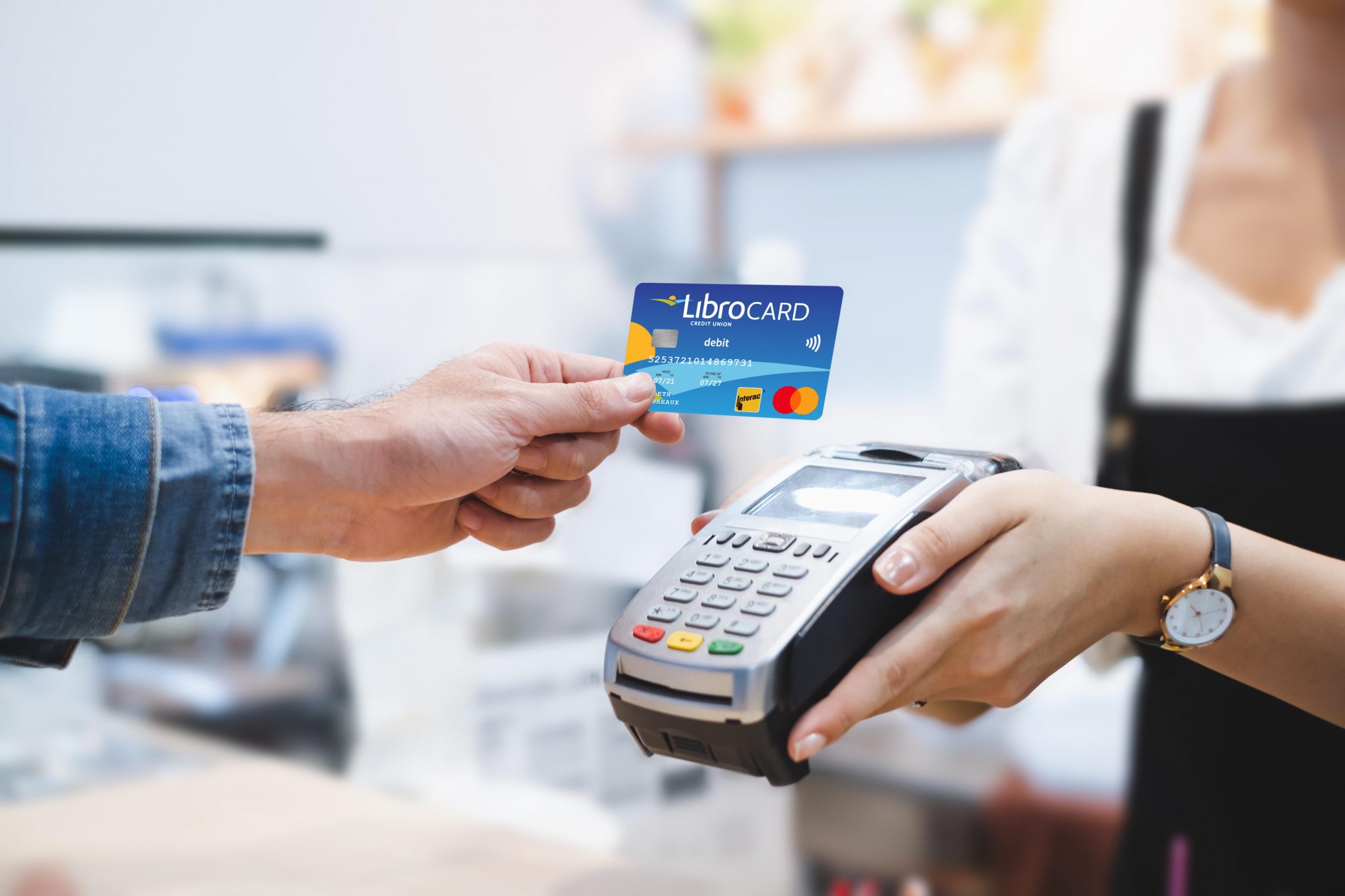Customer using Libro Card for payment to owner at cafe