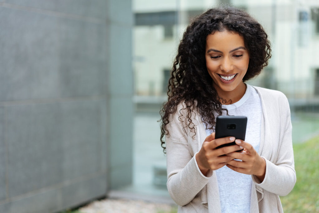woman smiling looking at phone