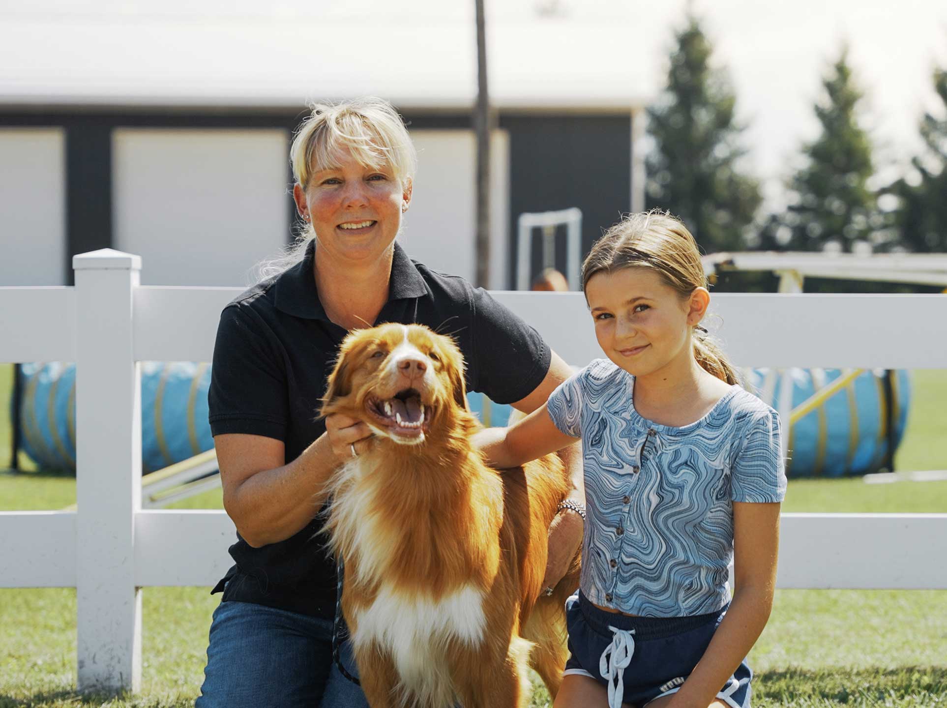 Happy mother and daughter with dog at Country Club for Pets