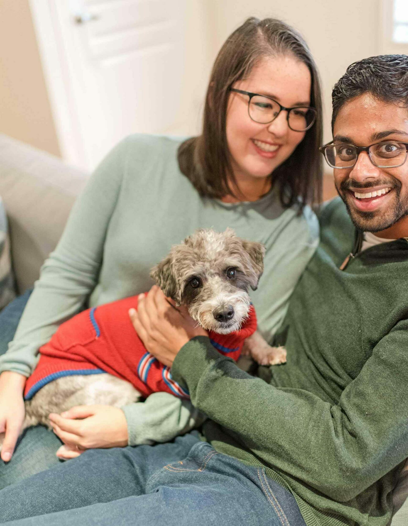 Happy couple on couch with dog