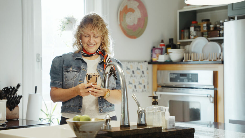 Libro Member, Noella, smiling while looking at her phone