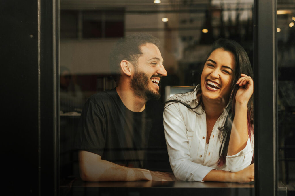 Two people sitting together laughing
