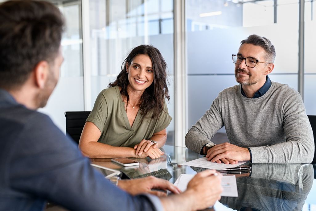 Couple sitting at a table talking to an advisor