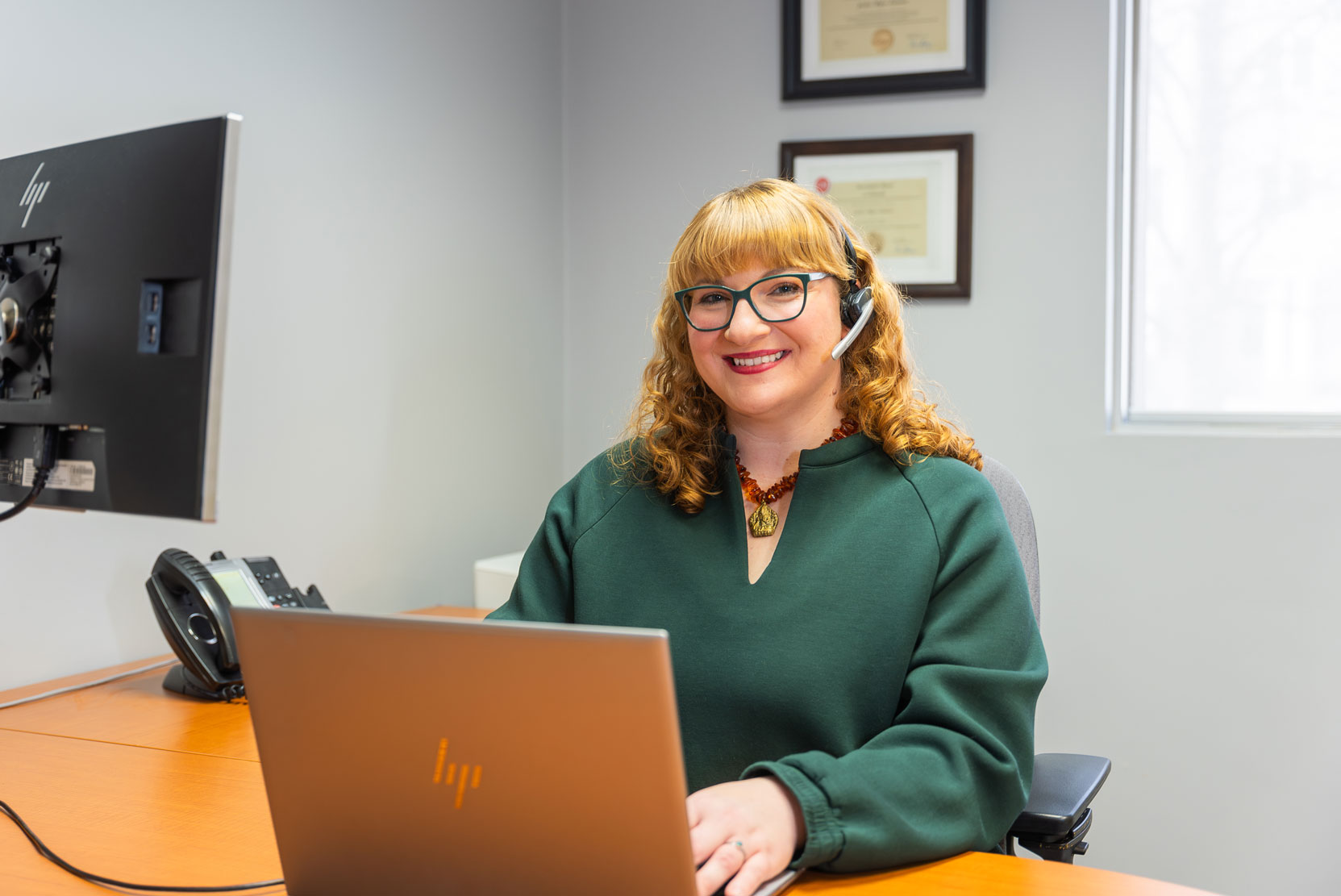 Libro Staff member on a computer taking calls