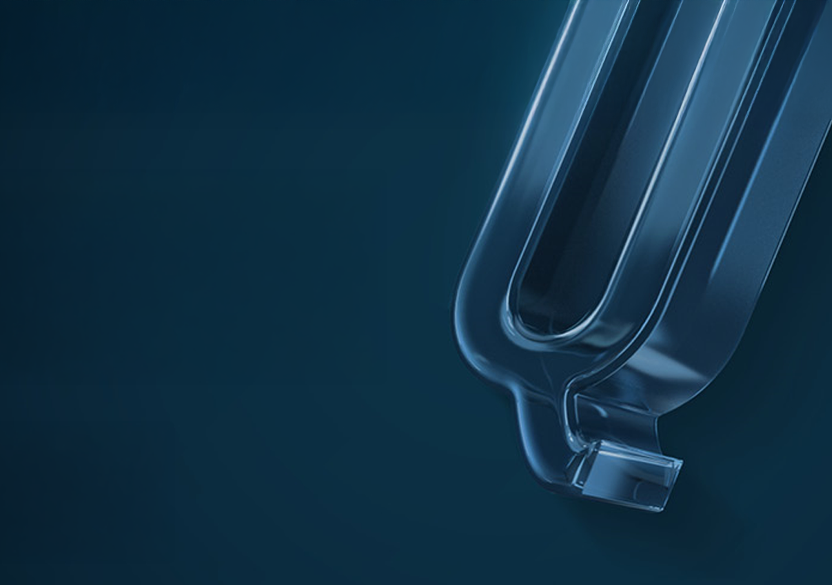 Close-up of a transparent, U-shaped glass tube against a dark blue gradient background.